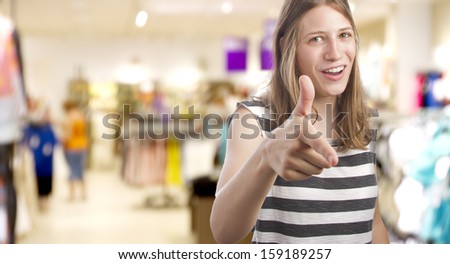 young girl pointing you in a shopping center