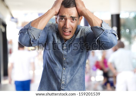 young man afraid in a shopping center