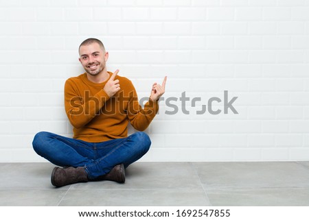 Similar – Image, Stock Photo Man sits on a white horse bridled with a bosal and looks for a carrot in his jacket pocket in thanks for the horse carrying him. In the background are blurred autumn trees.