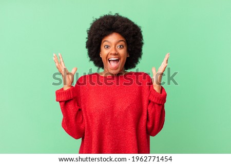 afro black woman feeling happy, excited, surprised or shocked, smiling and astonished at something unbelievable Foto stock © 