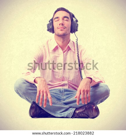 young man listening music by headphones.