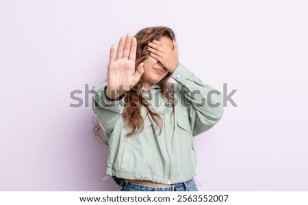 Similar – Image, Stock Photo Confident ethnic lady covering eye with hand in red studio