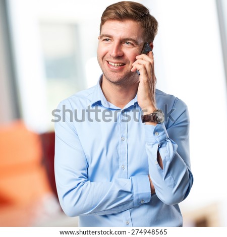 blond man speaking on phone