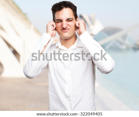 happy young man covering ears