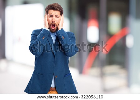 scared businessman covering ears