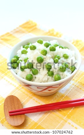 Japanese cuisine green-peas rice in rice bowl with chopsticks