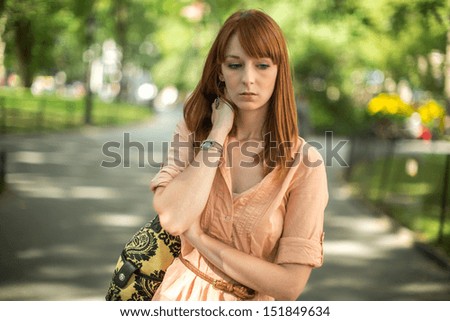Caucasian woman female sad worried face walking in a park
