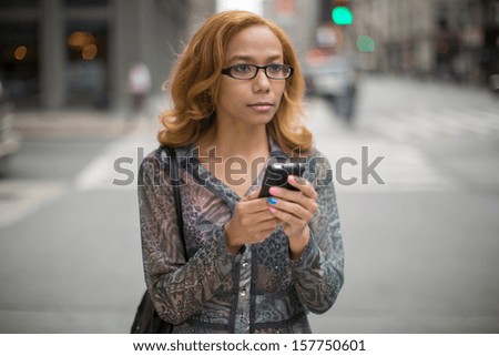 Latin Hispanic Asian woman using cellphone iphone smartphone texting message on city street