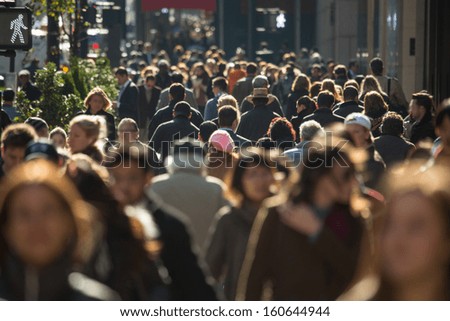 Photo of Crowd of anonymous people walking on busy New York City street
