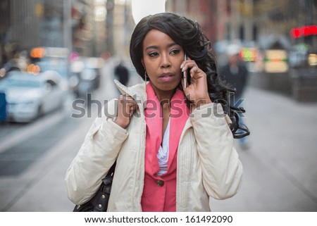 African American black cosmopolitan woman in New York City talking on cellphone