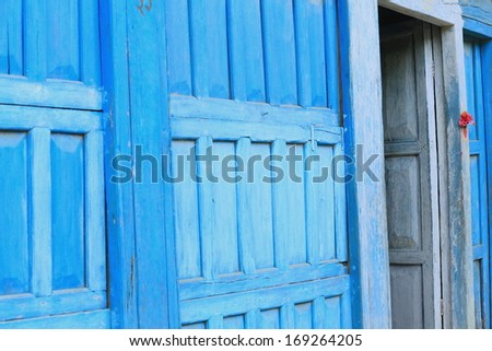 Blue painted wooden door at the entry to an old newari style traditional house in the main street of Bandipur-Tanahu District-Gandaki Zone-Nepal.