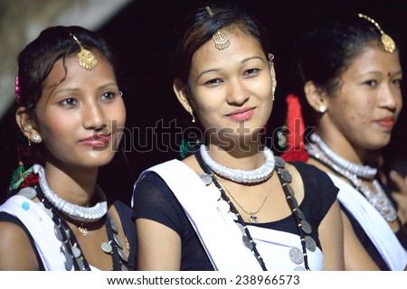 PATIHANI, NEPAL - OCTOBER 13: Girls of Tharu people in traditional dressing perform music and dance for tourists-Safari Narayani Lodge on October 13, 2012 in Ghatgain-Patihani-Chitwan-Narayani-Nepal.