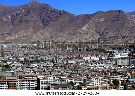 View over Lhasa city to the N.of the Potala palace including the Potrang Karp and Marpo-White and Red palaces on Marpo Ri-Red Hill risaing 300 ms.over Lhasa-Tibet.