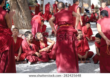 SERA, TIBET, CHINA - OCTOBER 19: Monks debate on doctrine-learning process-better comprehension of philosophy on October 19, 2012. Sera-Wild Roses monast.of Gelugpa-Yellow Hat order. Lhasa pref.-Tibet