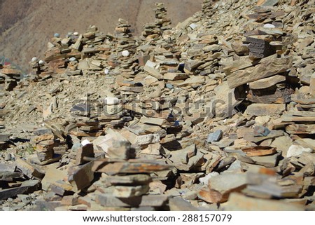 Some cairns-stacked stones seemingly of slate half way up to the 4793 ms.high Kamba La-pass on the Southern Friendship Highway. Lhoka or Shannan pref.-Tibet.