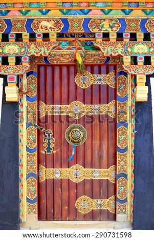 Profusely decorated-traditional tibetan style-wooden door in the old area of the town. Gyantse city and county-Shigatse pref.-Tibet.