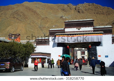 SHIGATSE, TIBET, CHINA-OCTOBER 23: Tibetan devotees pass in and out through the gateway of the Tashilhunpo-Heap of Glory monast.seat of Panchen Lama on October 23, 2012. Shigatse city and pref.-Tibet.
