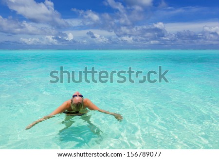 young woman enjoying the warm waters of the tropical sea