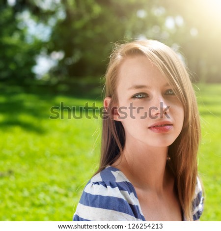 pretty teen girl outside at the park with copy space composition