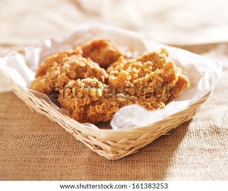 fried chicken pieces in a basket