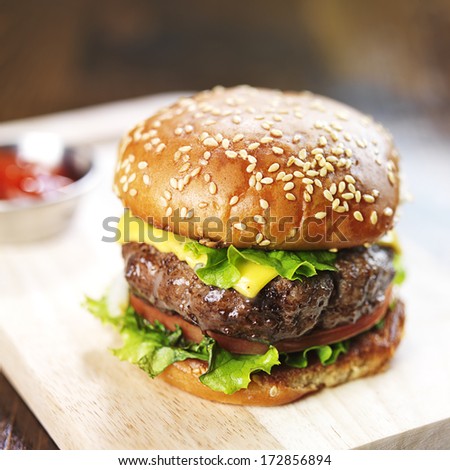 burger with sesame bun and melted cheese close up