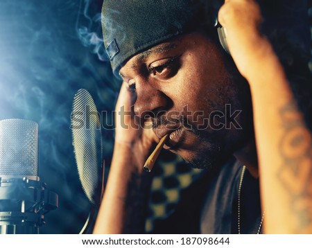 rapper with joint in recording booth