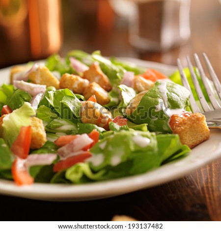 salad with ranch dressing, tomatoes, onions, and croutons