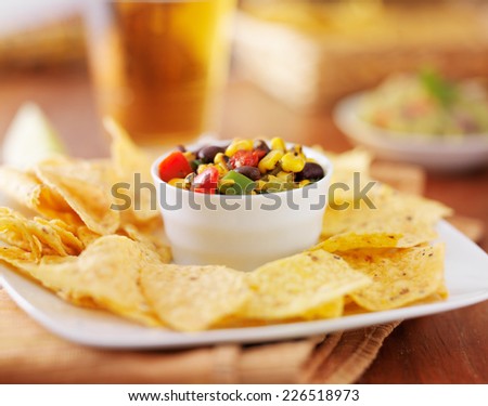 mexican fire roasted corn and black bean salsa with tortilla chips and beer