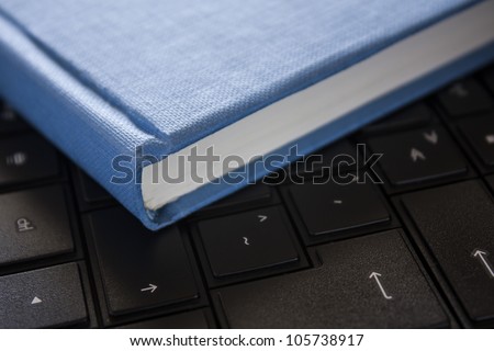 blue book on black computer