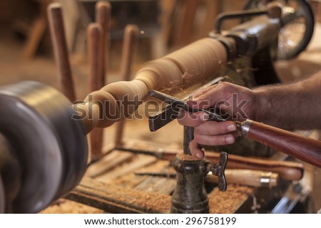 worker turning wood on a lathe