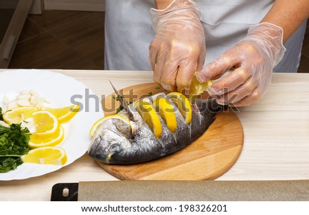 Cooked fish  sea bream fish with lemon, parsley,garlic.