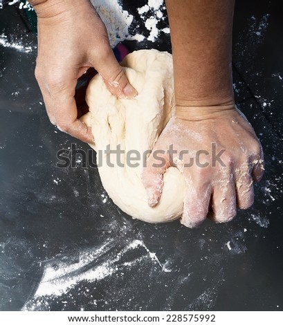 Hands kneading a dough