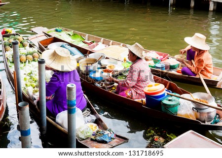 BANGKOK, THAILAND - JUNE 9: Unidentified market women sell fastfood from boat on June 9, 2012 in Amphawa river market, Thailand. The most popular river market in Thailand.