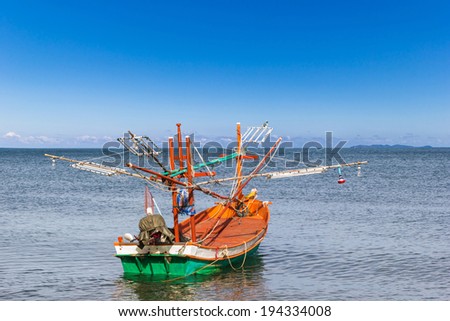 Fishing boat at clean beach on daylight