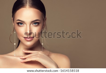 Beautiful girl . Fashionable and stylish woman in trendy jewelry big earrings .  Fashion look  , beauty and style. Natural makeup & easy styling Stock fotó © 
