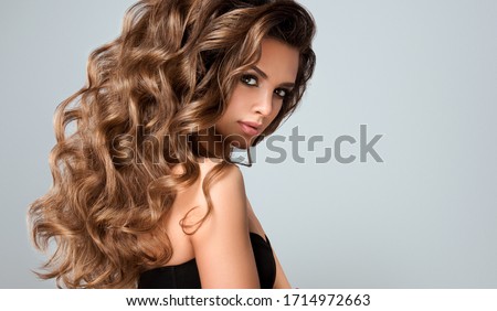 Beautiful model girl with long wavy and shiny hair . Brunette woman with curly hairstyle
 Foto stock © 
