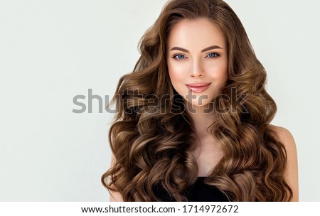 Beautiful laughing brunette model  girl  with long curly  hair . Smiling  woman hairstyle wavy curls . Red  nails manicure .    Fashion , beauty and makeup portrait
 Foto stock © 