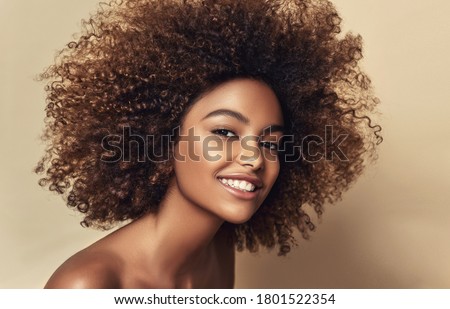 Beauty portrait of african american black woman with clean healthy skin on beige background.  Smiling beautiful afro girl.Curly  hair

 Foto stock © 