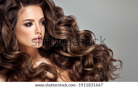 Beautiful laughing brunette model  girl  with long curly  hair . Smiling  woman hairstyle wavy curls .     Fashion , beauty and makeup portrait
 Stock foto © 