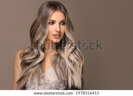 beautiful girl  hair coloring in ultra blond. Stylish hairstyle curls done in a beauty salon. Fashion, cosmetics and makeup. Сток-фото © 