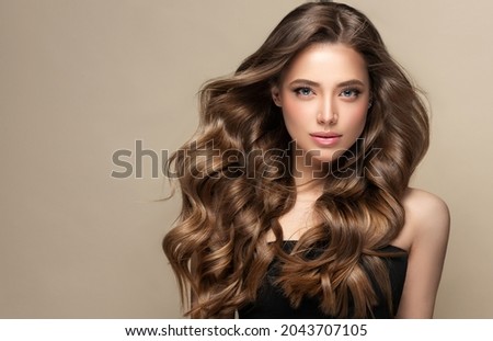 Beautiful laughing brunette model  girl  with long curly  hair . Smiling  woman hairstyle wavy curls .     Fashion , beauty and makeup portrait
 Foto d'archivio © 