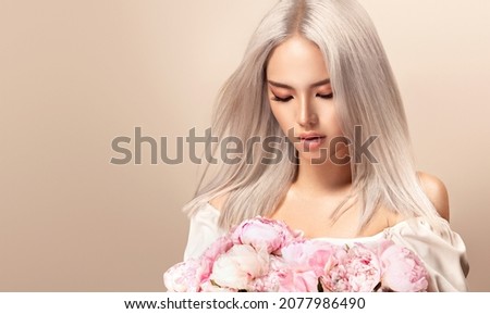 Image, Stock Photo Young blonde asian woman in knitted turtleneck sweater with fairy lights and bokeh around