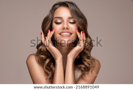 Beauty brunette girl with long shiny curly hair . Beautiful  smiling woman model  wavy hairstyle . Cosmetology, cosmetics and make-up. Stock foto © 