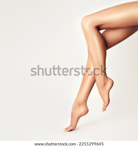 Similar – Image, Stock Photo Legs of a woman in a white culotte with colorful geometric shapes on a cobbled pavement. Casting shadows. Walking, pedestrian