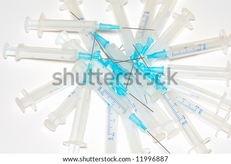 heap of used disposable syringes