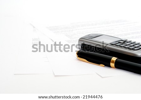 mobile phone and ink pen on the documents
