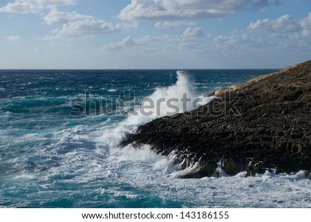 Huge waves crashing on the rocks in Malta, Zurieq. Huge wave explosion onto rocks. Large wave crash against the rocks during a storm in the tropics. Huge waves crash on cloudy day. Malta.Popular place