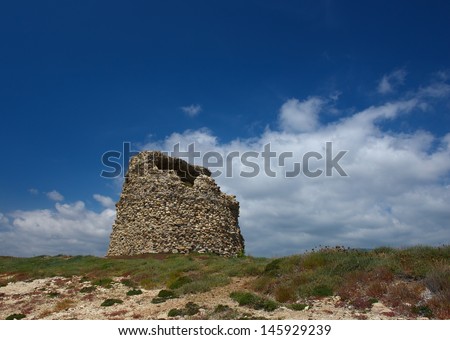 The nuraghe (nuraghi, nuraghes) is ancient megalithic edifice,symbol of Sardinia and the Nuragic civilization.Ancient traditional nuraghe building in Sardinia,Italy on sunny and cloudy sky background