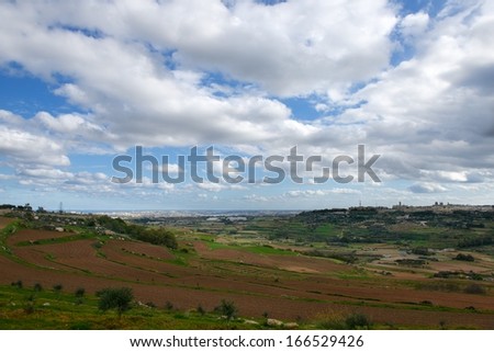 Maltese landscape, Malta, Countryside Scenery In Malta, cultivated fields on cloudy day, panoramic view,view of mediterranean Maltese islands, fields and nice cloudy sky on sunny day, maltese nature