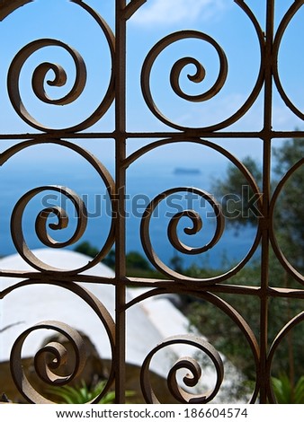 Artistic photo of small maltese island Filfla in Malta looking trough the railing. Romantic view to small island. Sadness and serenity mood. Solitude mood. View to the sea in frame, Malta